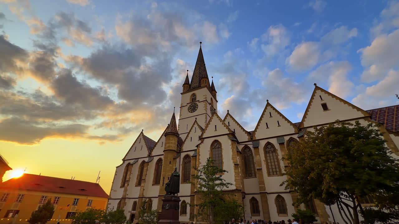 Sunset view of Lutheran Cathedral in Sibiu. The Evangelical Cathedral in Sibiu, Romania, seen at sunset with dramatic clouds in the background