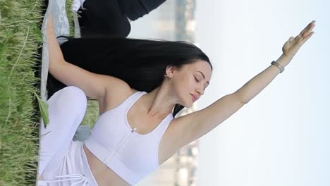 beautiful women doing yoga exercises of stretching beautiful women doing yoga exercises of stretching body at nature on the mat they concentrated and relaxed practicing yoga meditation poses while taking a fresh air at nature slow motions