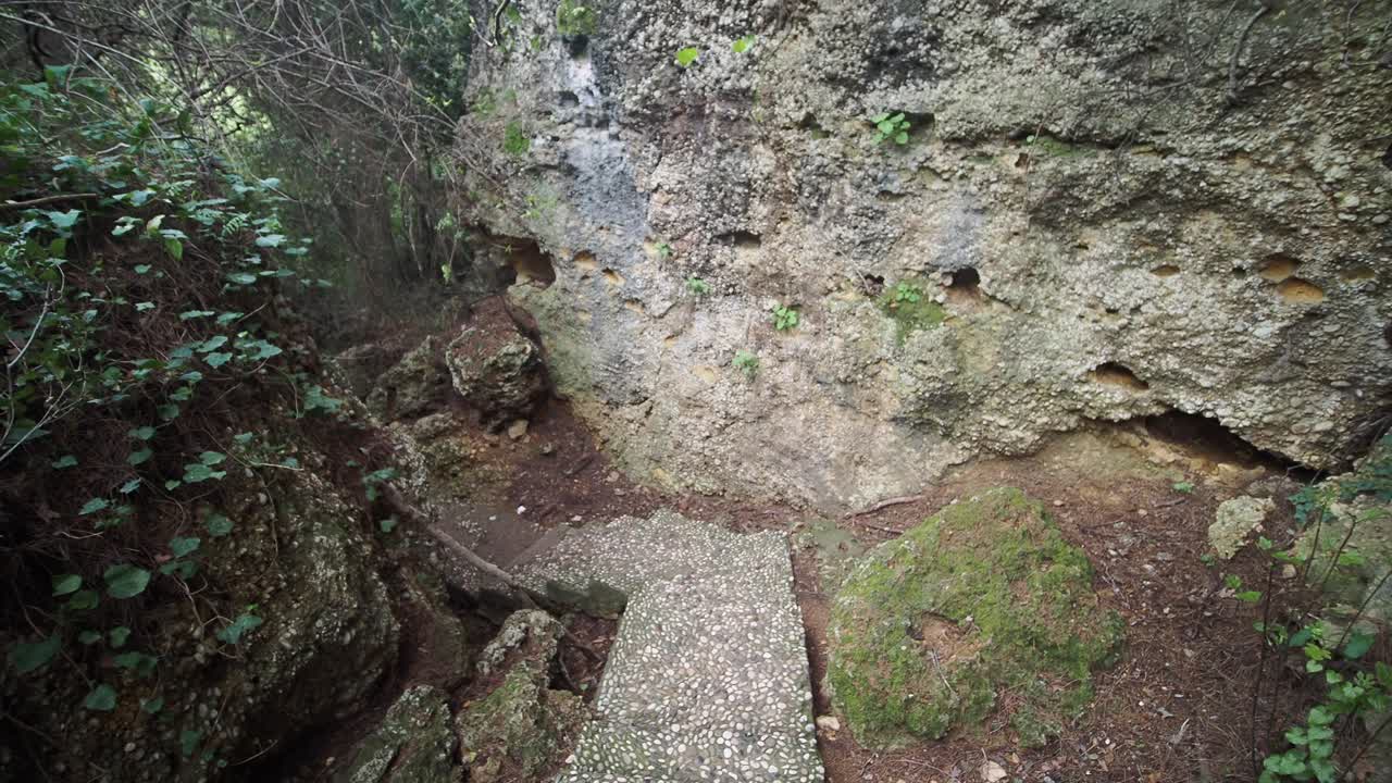 Ancient Stone Steps Descending into a Natural Grotto