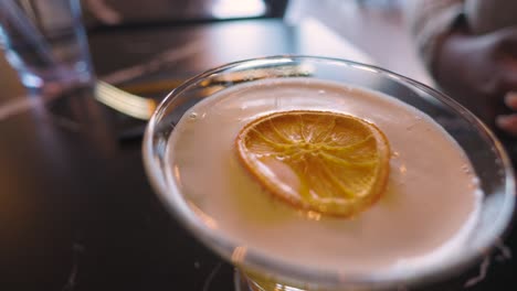 close up view of a mix cocktail with a orange slice at a local restaurant bar