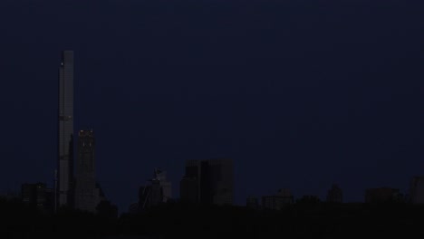 A captivating timelapse shows a strawberry moon setting over billionaire row at dawn, as viewed from Central Park&#039;s reservoir in midtown Manhattan