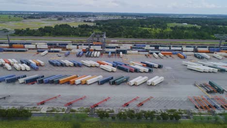 4k drone video of trains and trucks at csx intermodal train yard in winter haven, fl