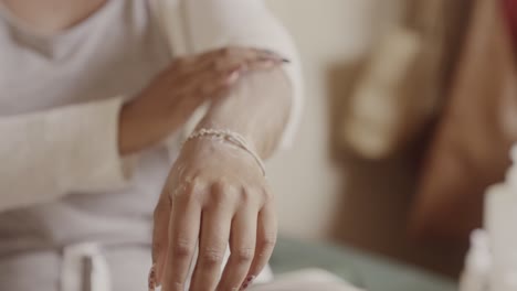 person applying lotion or cream to their arm