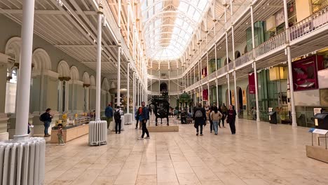 people exploring exhibits in spacious museum hall