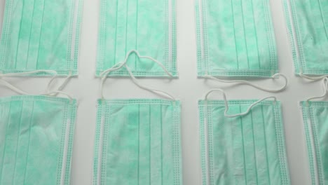 disposable surgical face masks displayed in row - overhead slide shot