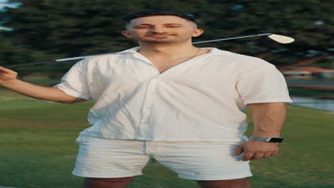 man in white outfit on a golf course