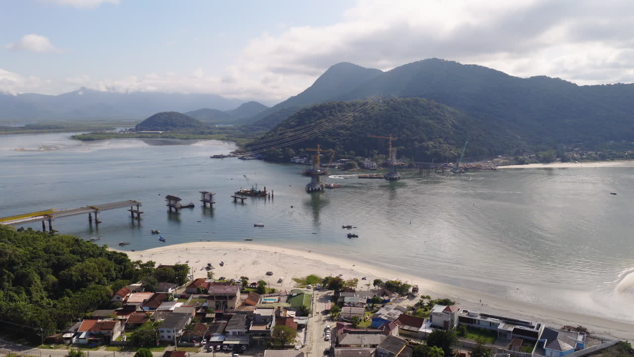 Aerial view of under construction new Guaratuba-Caiobá Bridge with mountainous backdrop, South America, Paraná, Brazil