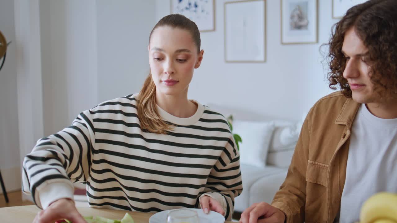 Couple enjoy family breakfast at kitchen table closeup. Two people preparing eat