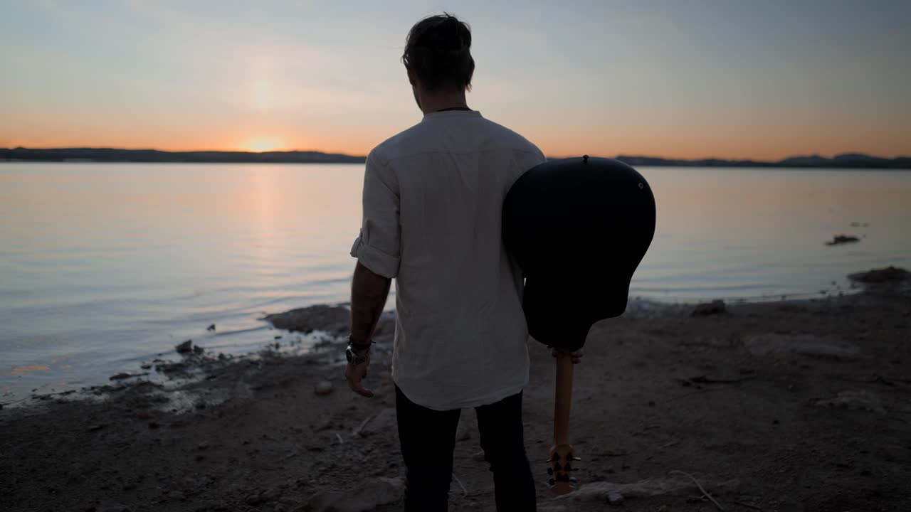 Man with Guitar at Sunset Lake