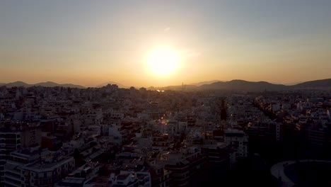 A-breathtaking-aerial-shot-of-the-sun-setting-over-Pireaus,-Greece