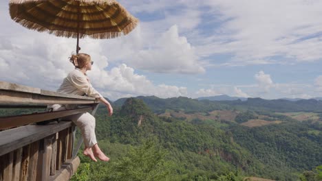 woman at ban jabo viewpoint enjoys a view with scenic mountain backdrop in mae hong son, thailand