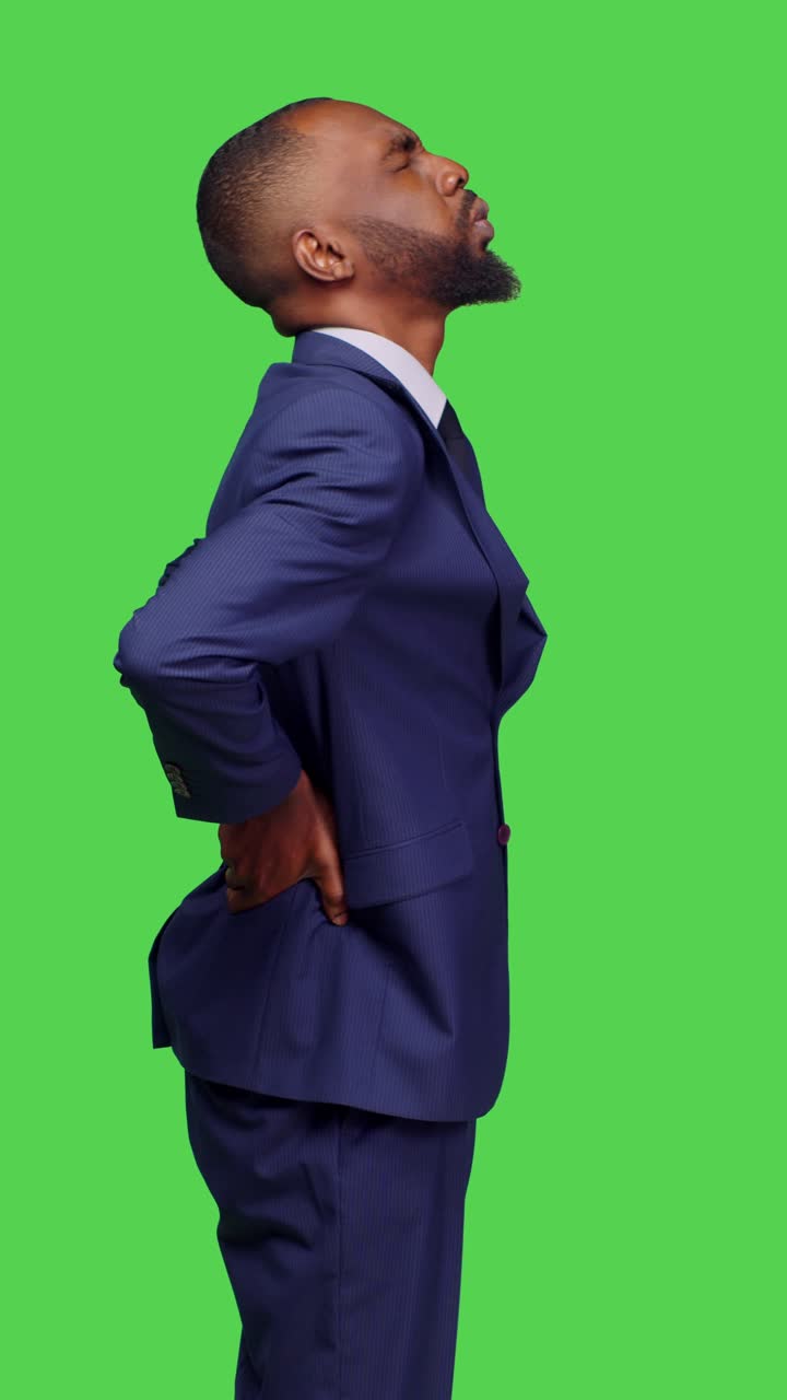 Vertical video: Profile of african american man having muscle and spine pain