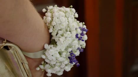 close-up of the maid of honor's wedding bouquet made of white and purple flowers