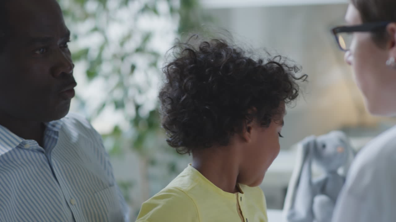 Child having a medical exam with doctor and father