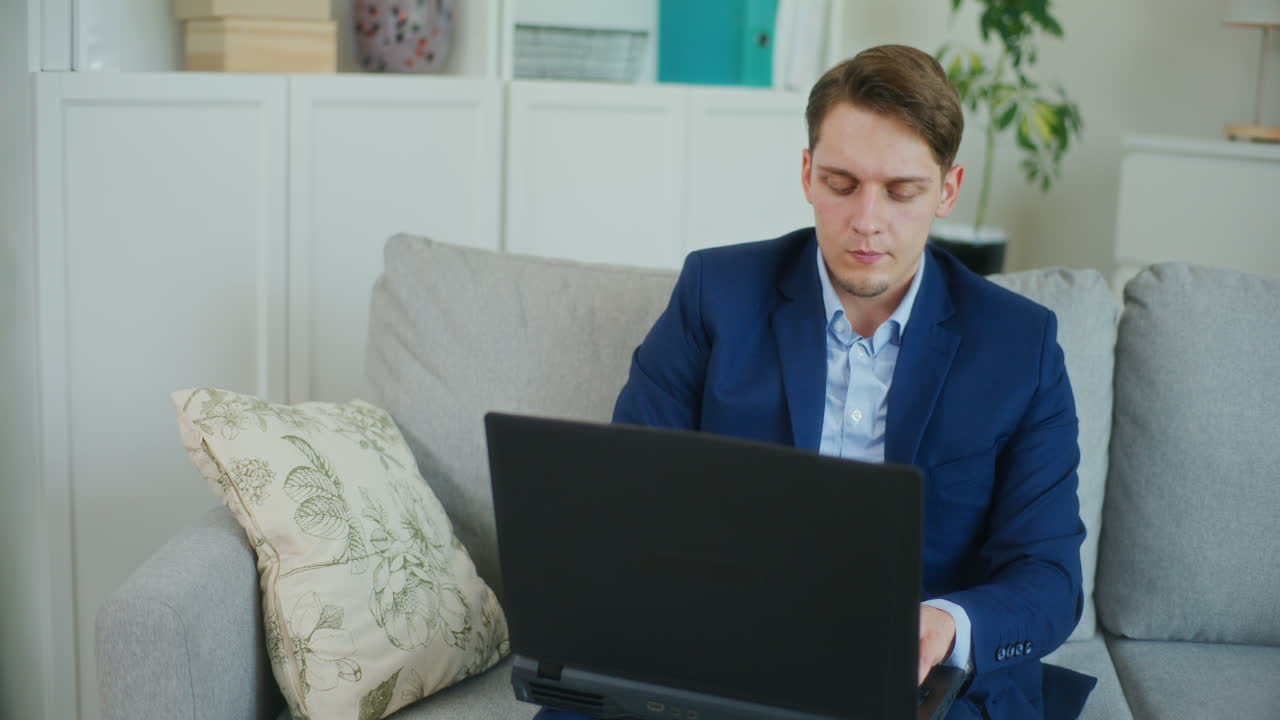 Confident Businessman Starts on Laptop