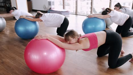 european women are doing renatal exercises with exercise balls and instructor