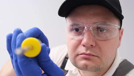 Portrait of a Builder Holding a Screwdriver on a White . Portrait of a builder holding a screwdriver on a white . Home renovation concept. video