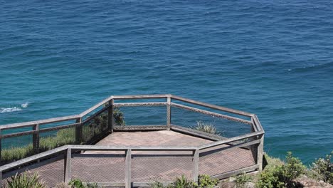 static view of an empty wooden deck by the sea.