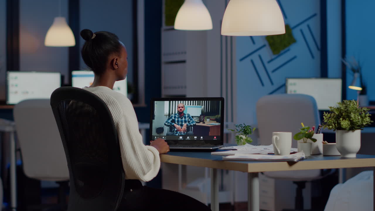 Black woman freelancer discussing with paralyzed client on video call