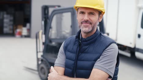 portrait of caucasian mature man in front of warehouse.