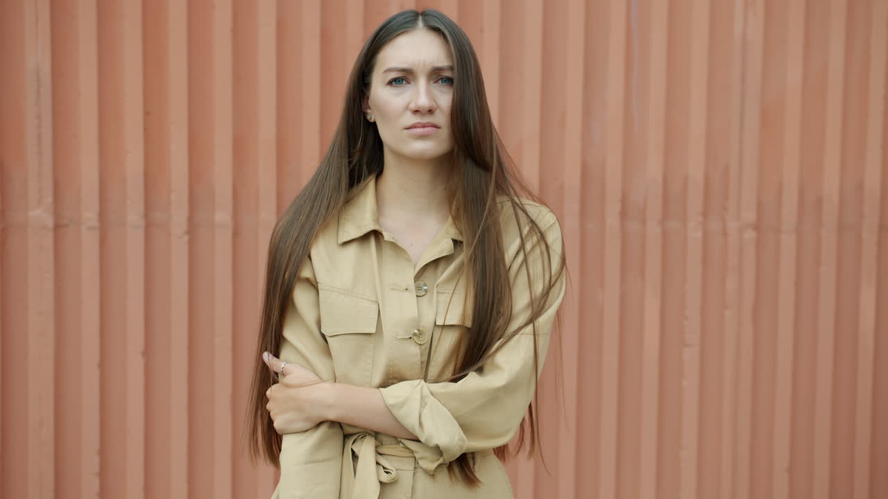 Woman in Beige Jumpsuit Against a Metal Wall