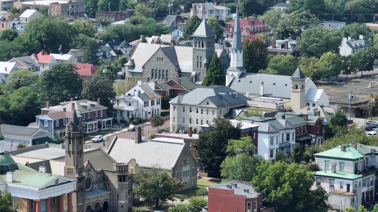 Historic churches and cathedral in American town during sunny day. Old ancient houses in small city of USA. Aerial wide shot. Lynchburg, Virginia