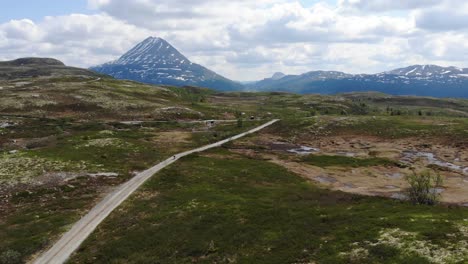 biking path on top of mountain in norway with gaustatoppen in the background