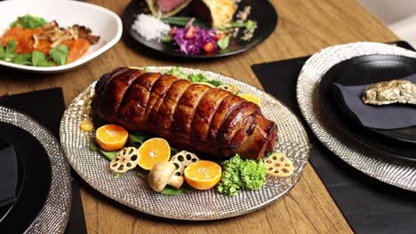 gourmet dinner table setting with roasted pork loin