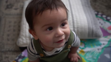 close-up-of-hispanic-baby-with-pillow-and-play-mat