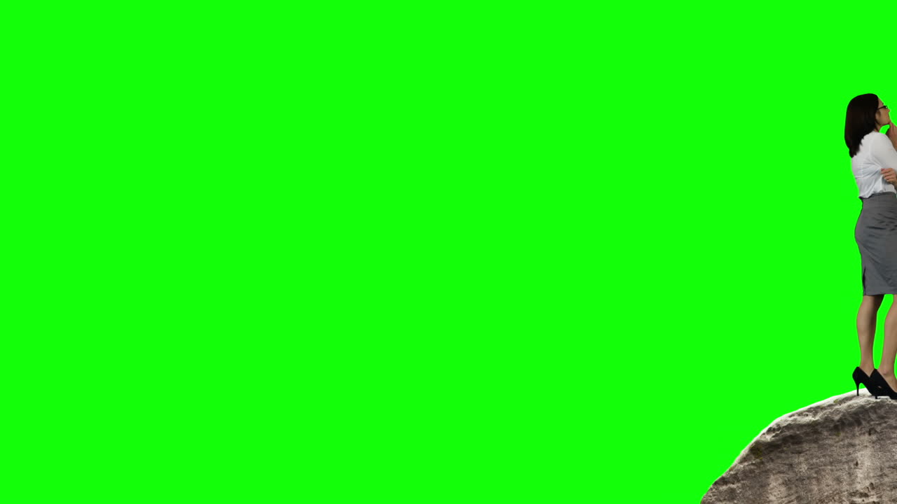 hombre de negocios y mujer de pie en las rocas mirando hacia afuera