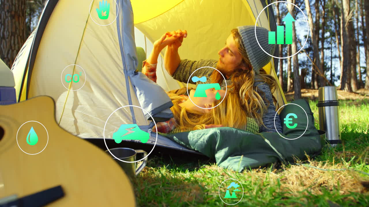 In tent, people relaxing with animation of environmental icons in natural setting