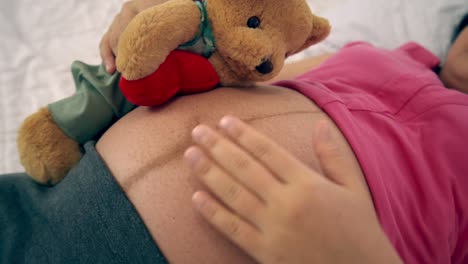 happy pregnant woman sleeping on bed in bedroom.