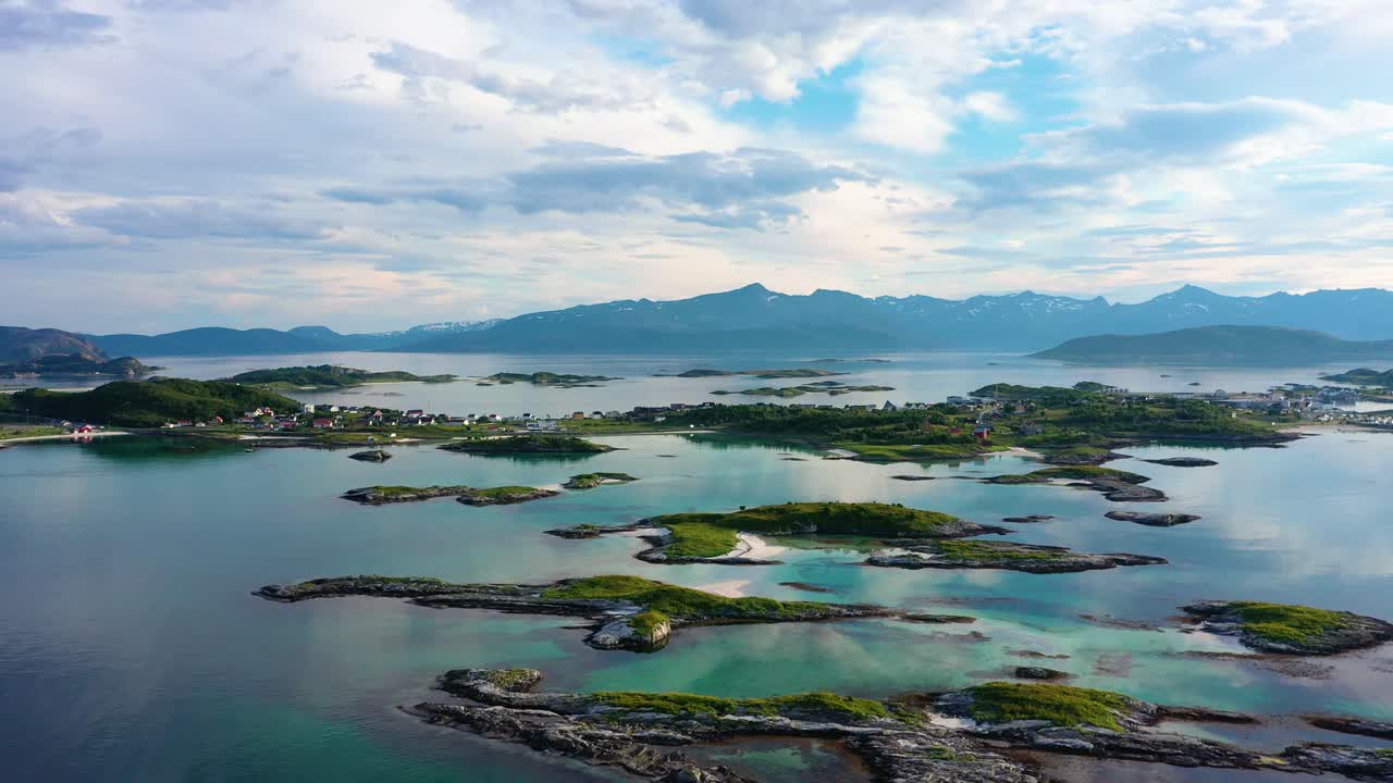 Aerial view of turquoise sea and white beaches at the Sommaroy islands, in the Barents sea, cloudy, summer day, in Troms, Nordland, Norway - rising, drone shot