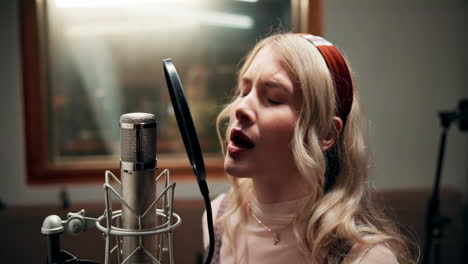 woman singing in a recording studio