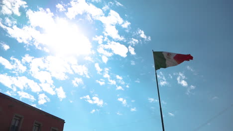 mexican flag waving in a blue sky