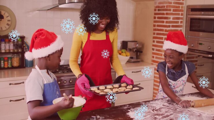Animation of snow falling over happy african american mother with children baking at christmas