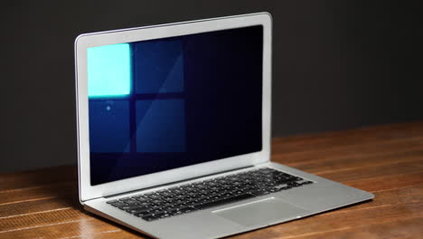 animación del procesamiento de datos con cuadrados azules en la pantalla del portátil