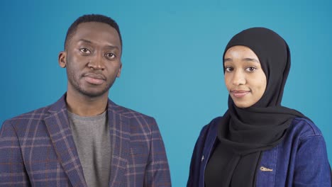 portrait of african young muslim man and african muslim young woman.