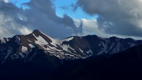 Old-mount-Snowmass-Resort-Colorado-aerial-drone-dark-clouds-sunset-Mt-Sopris-Sopras-Capital-Peak-Maroon-Bells-Aspen-Wilderness-summer-June-July-Rocky-Mountains-peaks-National-Forest-pan-down-slowly