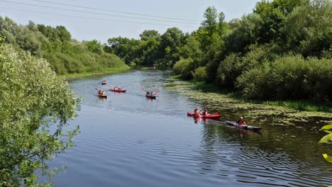 group of people are sailing on kayaks along a beautiful river