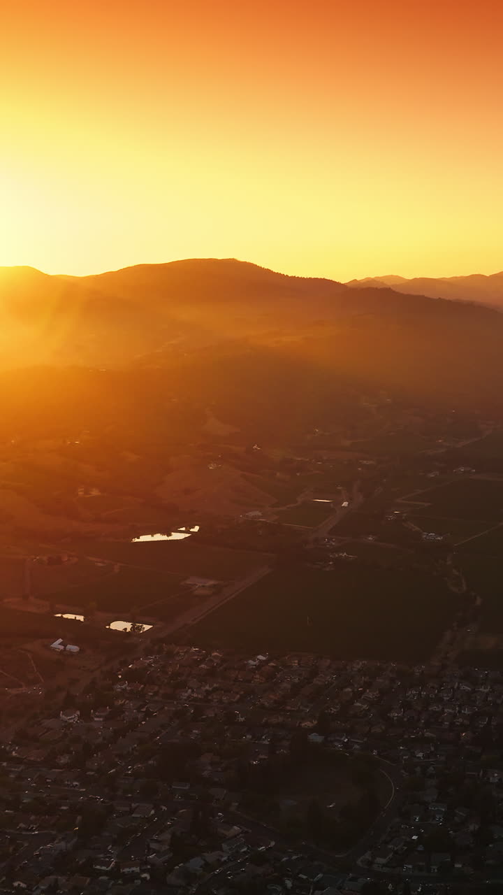Scenery of picturesque Napa, California, USA in the rays of setting sun. Amazing city at the backdrop of mountains and orange skies. Vertical video