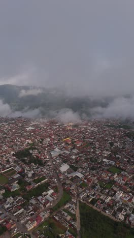 fluffy clouds drift above the scenic hills of zacatlan, puebla, mexico.