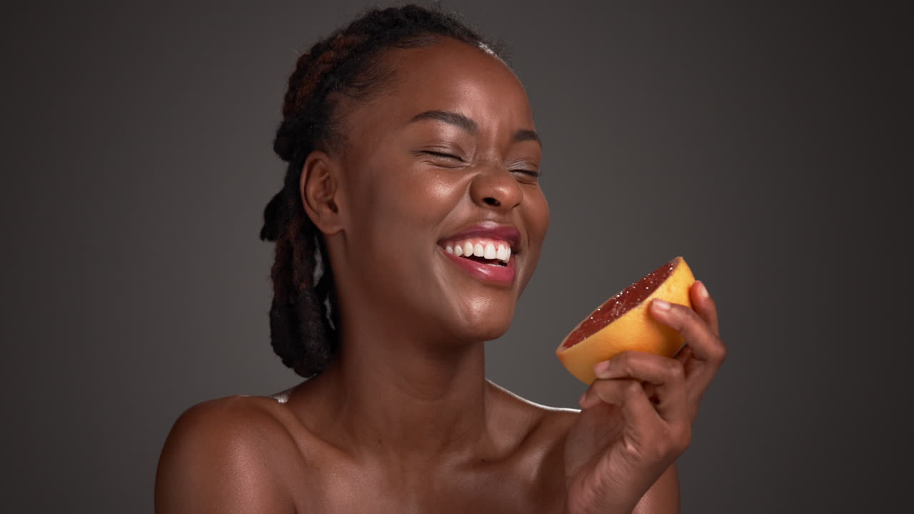 Woman smiling with grapefruit