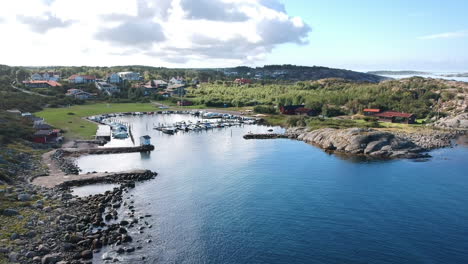 aerial drone shot of a small marina at the ocean coastline on the west coast of sweden in halland outside of gothenburg