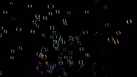 lot soap bubbles fly in the air black background lot of bright colorful soap bubbles do not fly very fast in the air black background