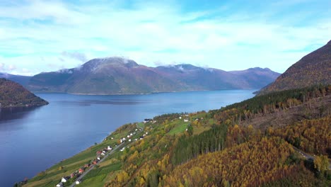 Hardangerfjord-with-Utne-and-mountain-Oksen-seen-from-Kinsarvik-and-Ystanes-in-Hardanger-Norway---Beautiful-sunny-day-aerial-with-blue-sky-during-fall-season