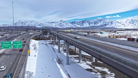 Antena-Junto-Al-Paso-Elevado-En-Salt-Lake-City-Spaghetti-Bowl,-Paisaje-Cubierto-De-Nieve