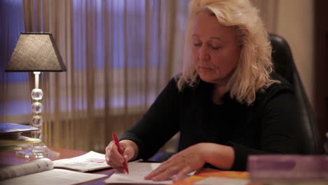 English-teacher-writes-something-sitting-at-the-table