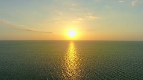 aerial view beautiful view sunset or sunrise over sea surface beautiful wave amazing light twilight sky sunset. cinematic drone shot dynamic footage beautiful light of nature seascape