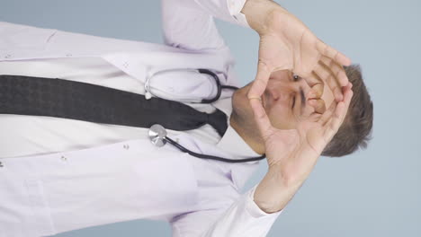 vertical video of doctor making heart looking at camera.